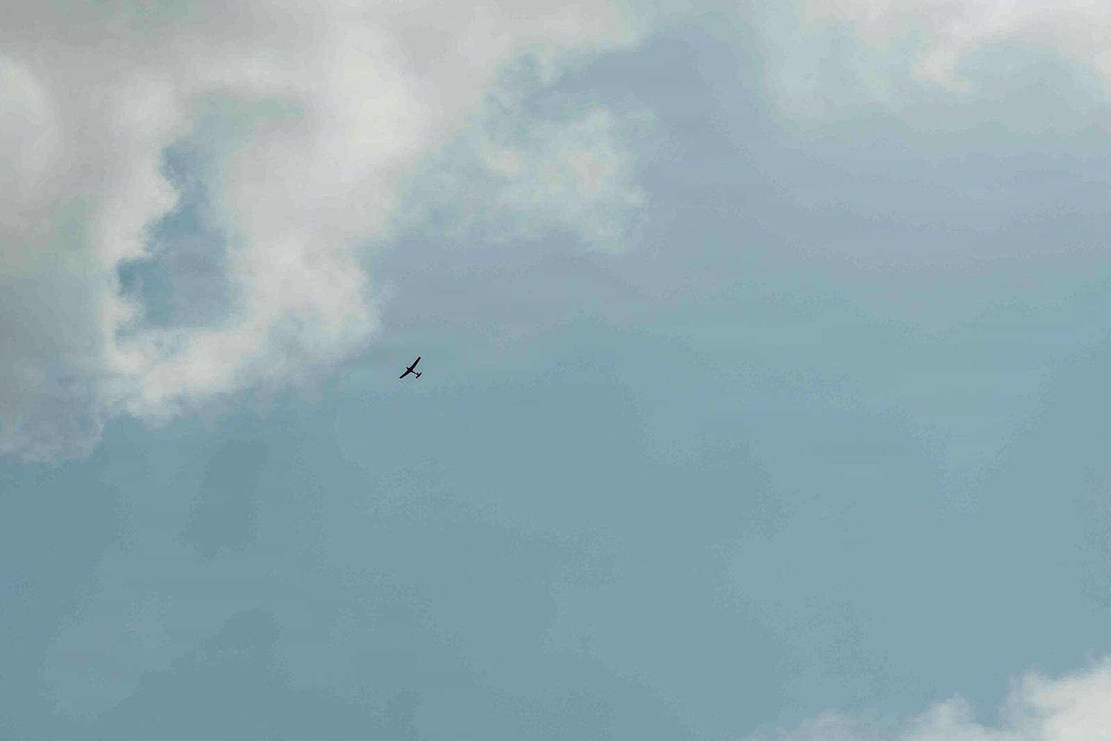A small unmanned aircraft alone against a large sky, far beyond reach of any intervention.