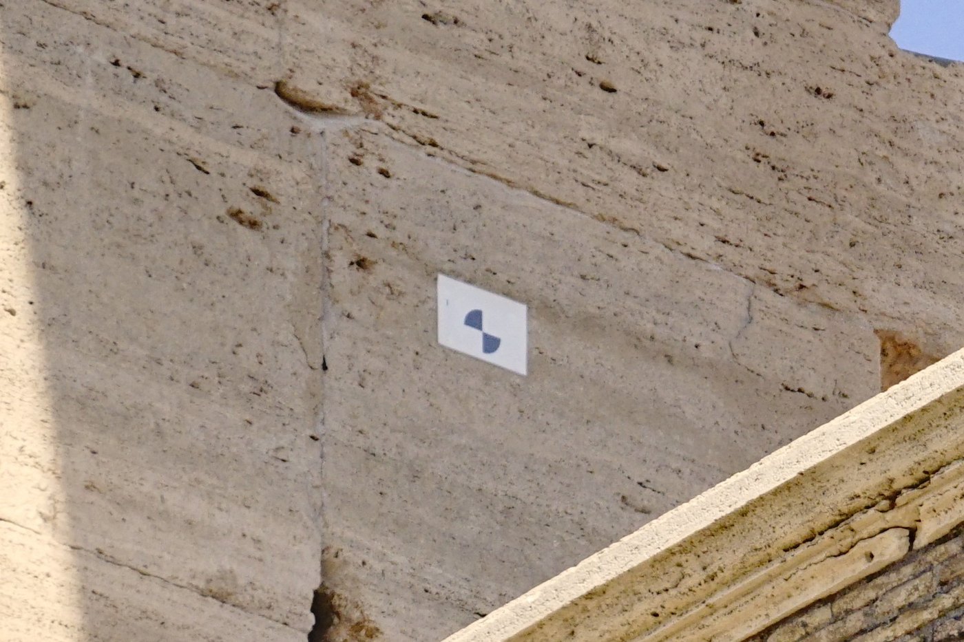 A coded fiducial target fixed to a stone structure, surveyed in as a known reference point.