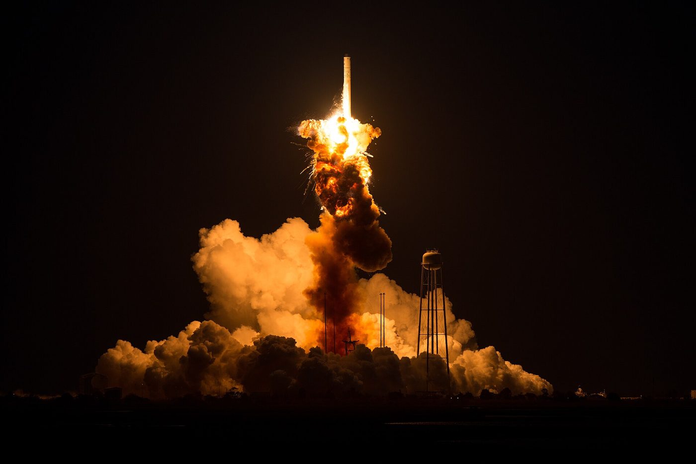 A launch vehicle destroyed shortly after lift-off, the failure contained above the pad.